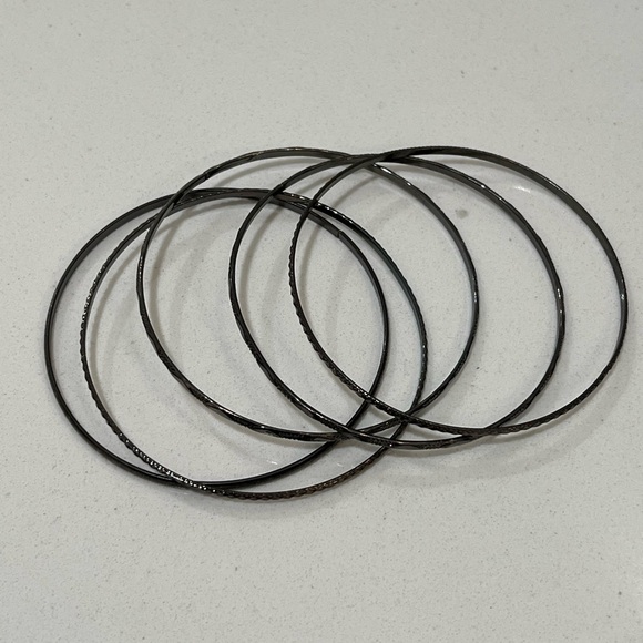 Black metal bracelet stack with different designs. - Picture 3 of 3